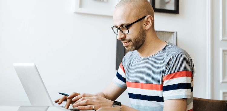 person sitting at home working on a laptop